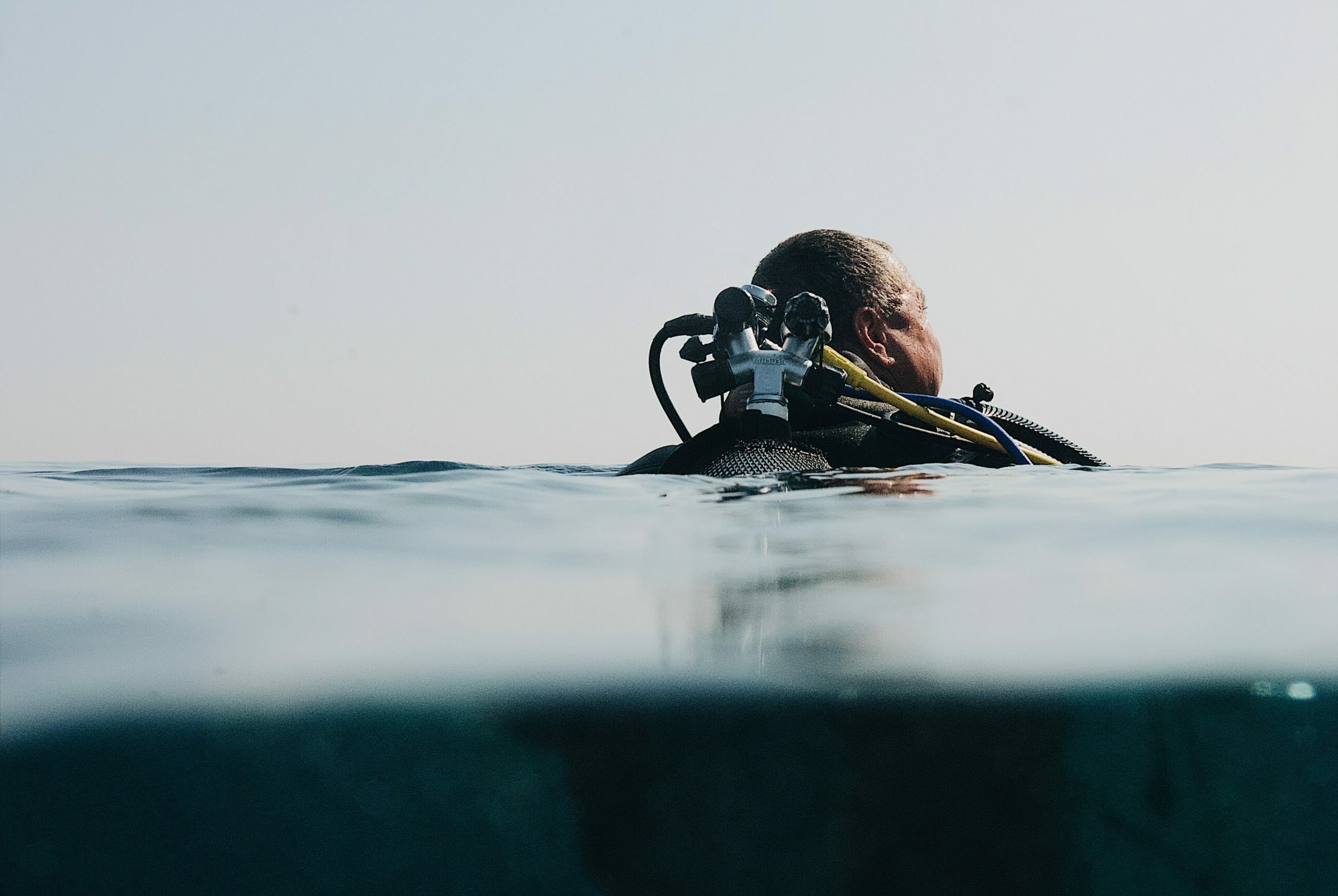 Diver at the surface left behind