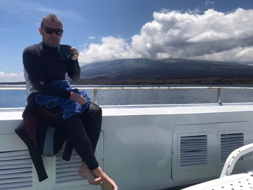 Mik relaxing on the sun deck of Galapagos Master, enjoying coffee and sunshine between dives.