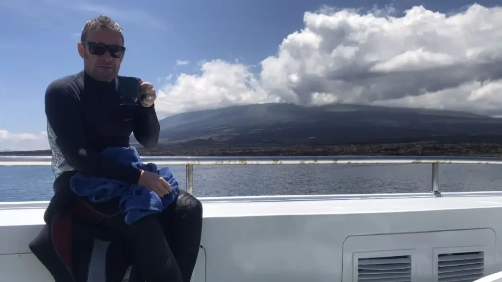 Mik relaxing on the sundeck of Galapagos Master, enjoying coffee and sunshine between liveaboard dives.