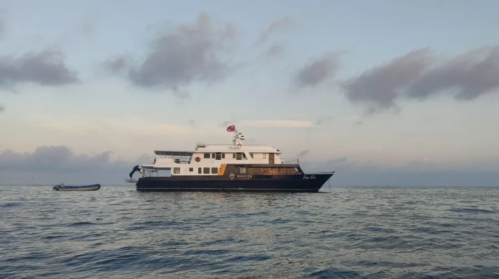 Galapagos Master dive vessel moored in the open ocean between dive