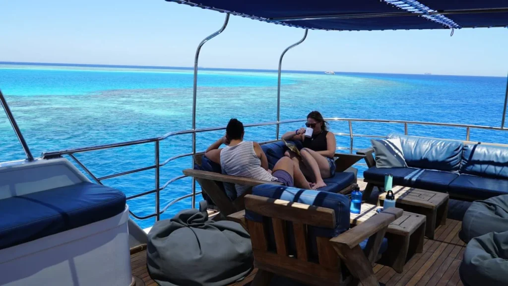 Spacious liveaboard sundeck with seating and sunbathing areas, perfect for families, couples, and friends to relax and enjoy shared moments between dives