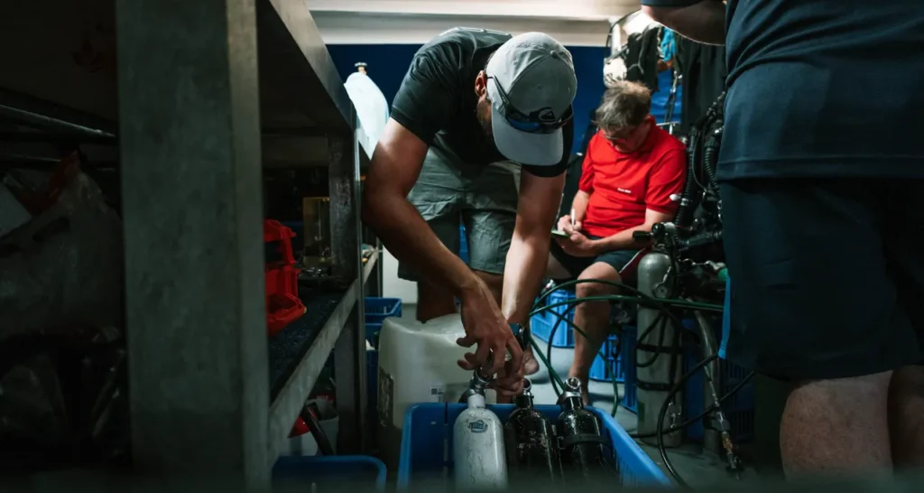 Liveaboard crew blending trimix and oxygen for technical diving operations