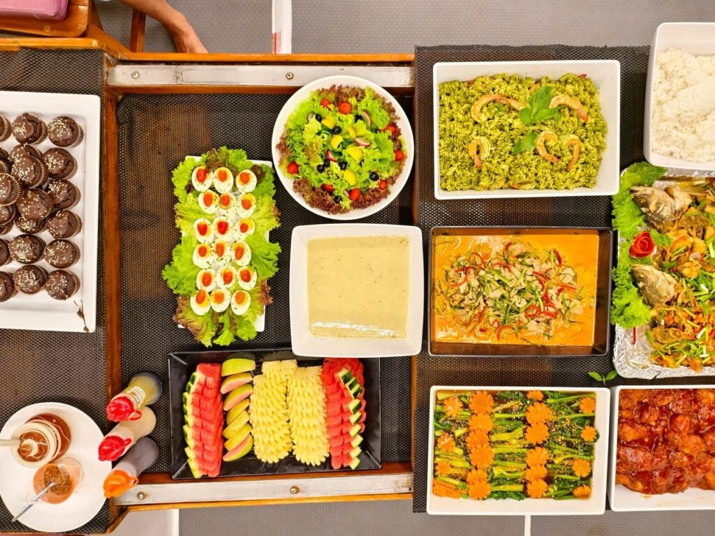 buffet-style meal at a long communal table in the boat's lounge.